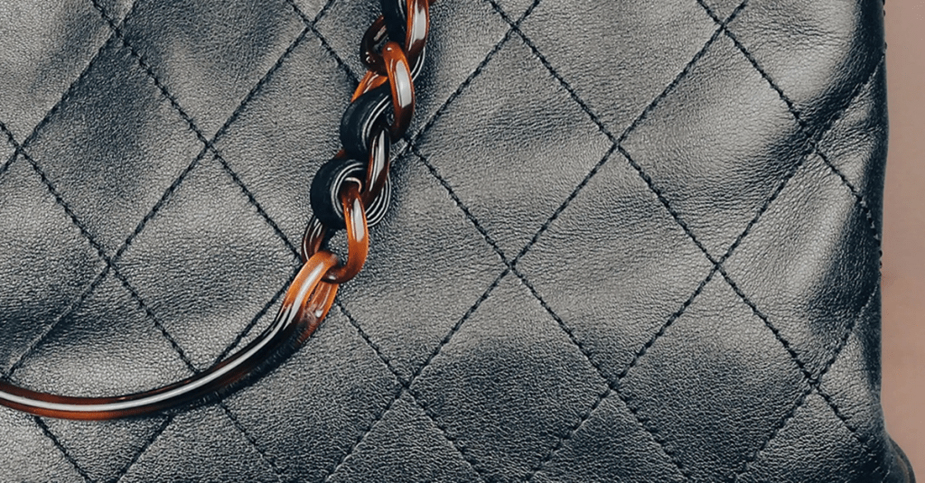 Quilt leather and handle detailing of a Chanel bag photographed by Cotswolds Content.