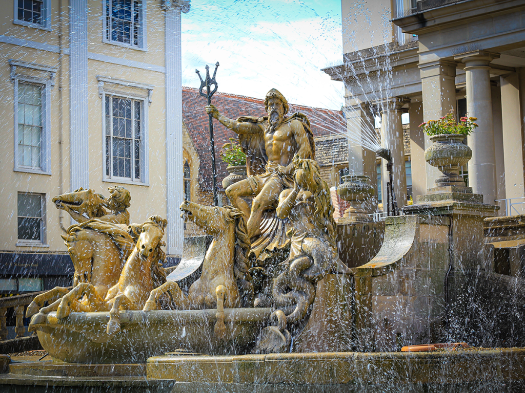 Neptune fountain in Cheltenham spraying water.