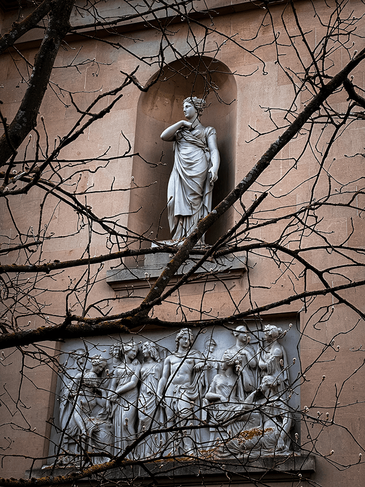 Acroterion detailing of a woman on a school building in Cheltenham.