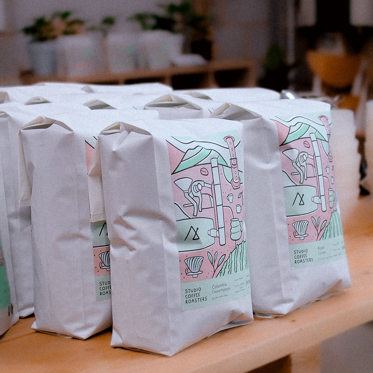 Studio Roasters bags of coffee on a table in the roastery.