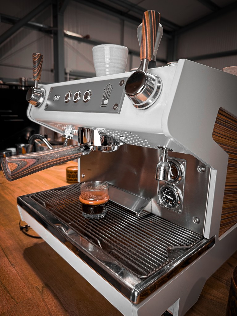 Studio Coffee Roasters white barista coffee machine with freshly roasted espresso.